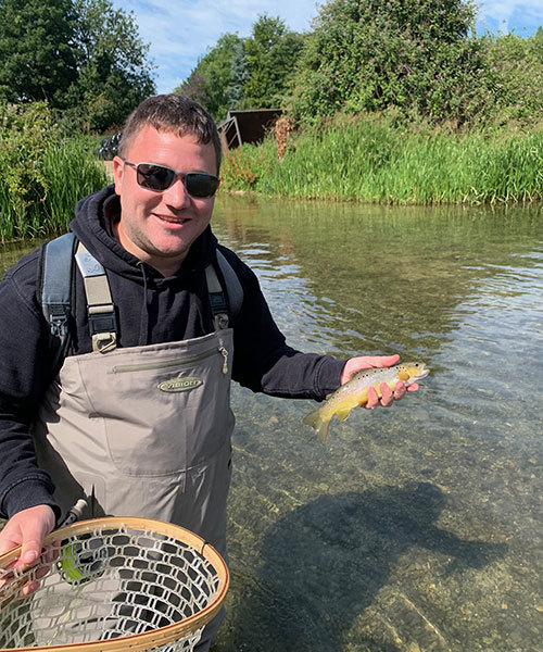 Man with fish on River Coln